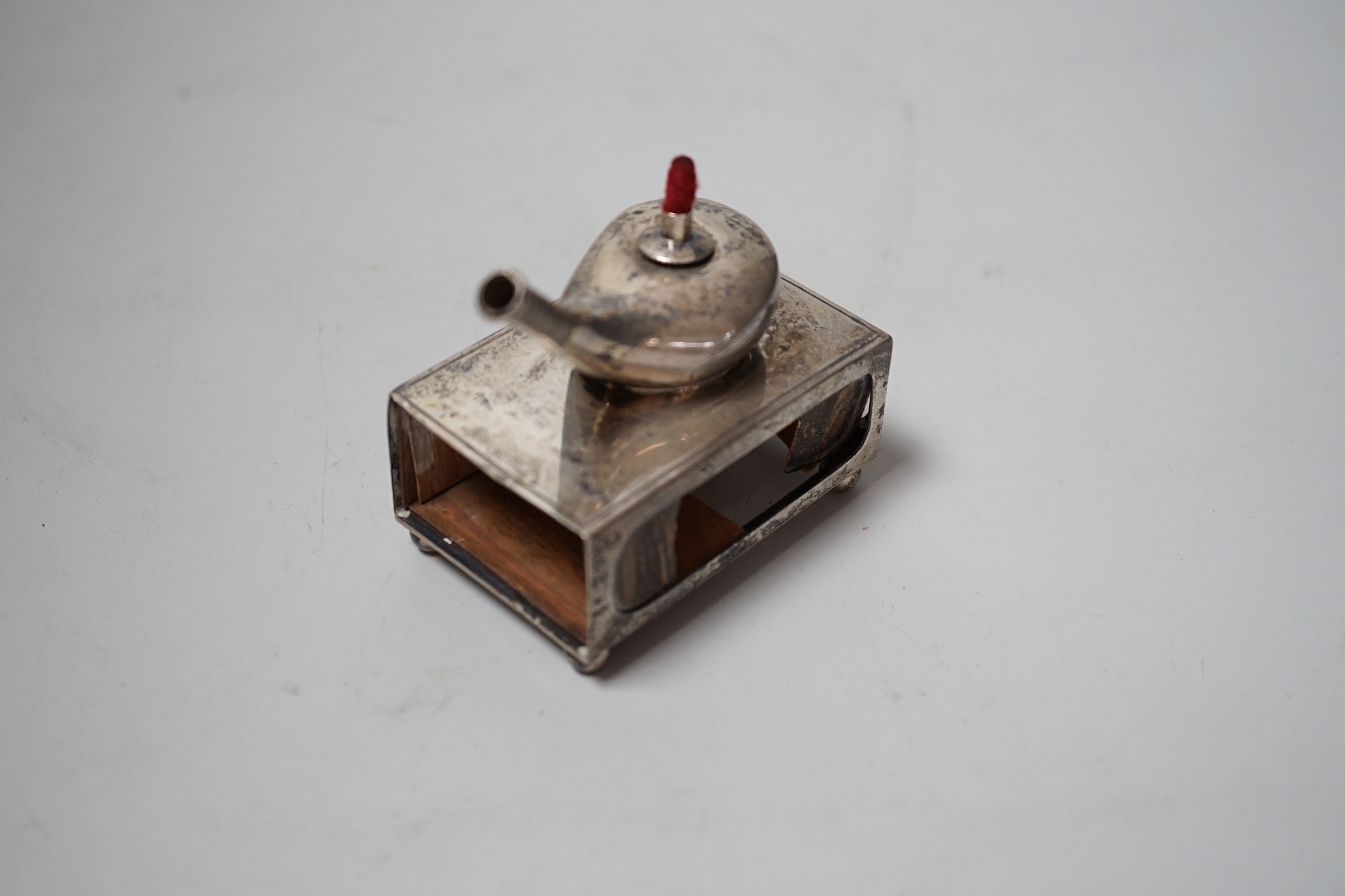 An unusual Edwardian silver matchbox sleeve, surmounted with a lamp shaped perpetual lighter, Crisford & Norris, Birmingham, 1908, 74mm.